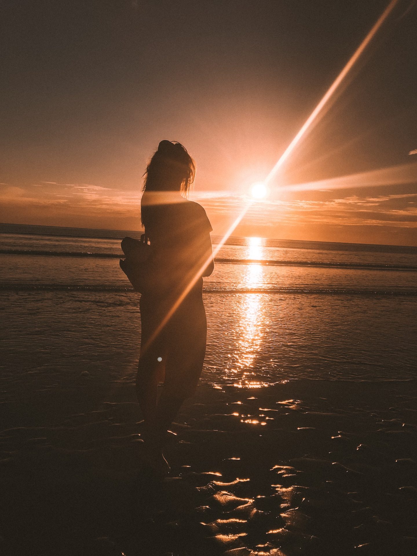 Girl on beach at sunset